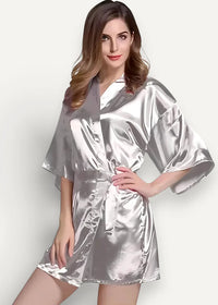 A shimmering silver satin robe for women with a belted waist and wide flowing sleeves