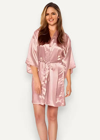 A soft pink satin robe for women with a matching tie belt made of smooth satin material