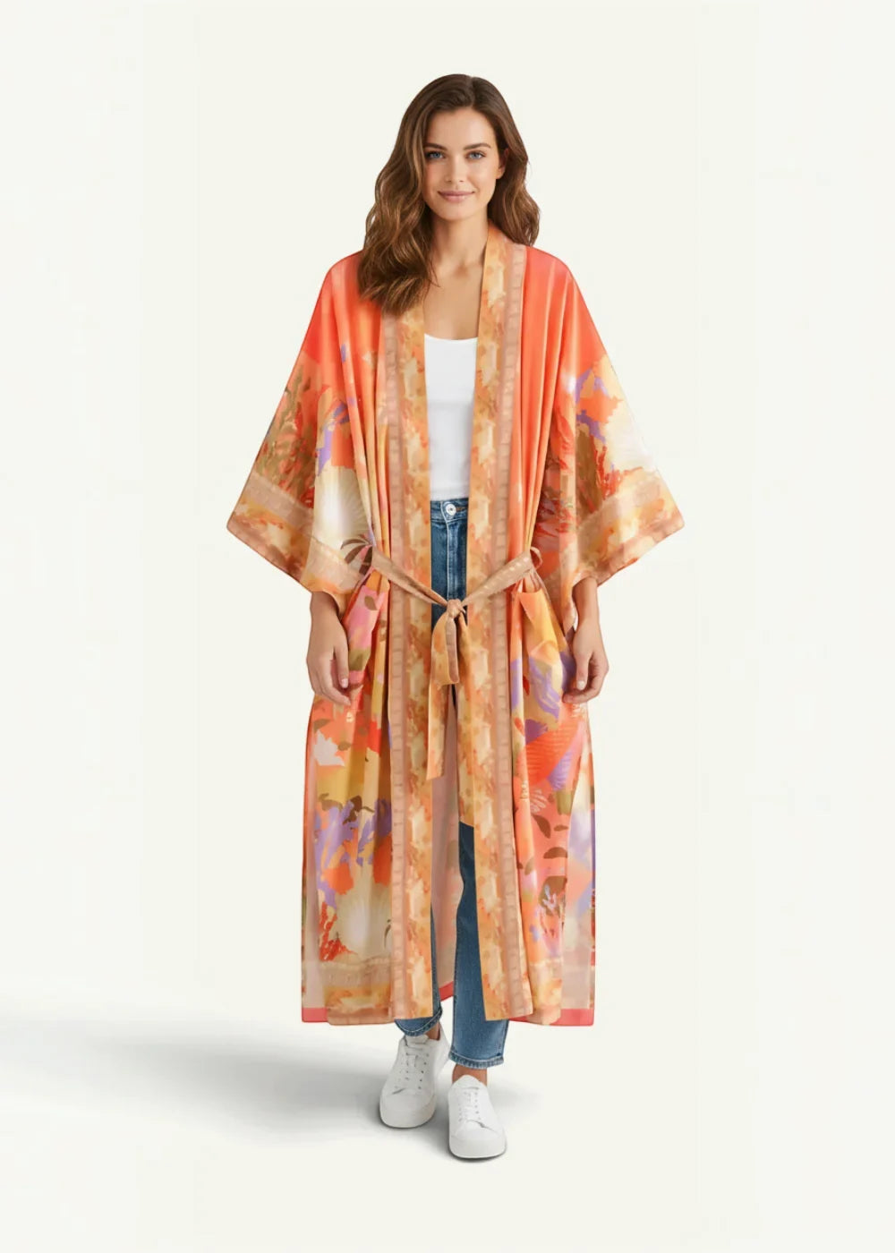 Sheer kimono cover up with flowing long sleeves in orange and cream featuring a vibrant abstract floral pattern