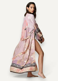 Sheer kimono with long sleeves flowing pink and beige floral fabric and black and gold patterned hem