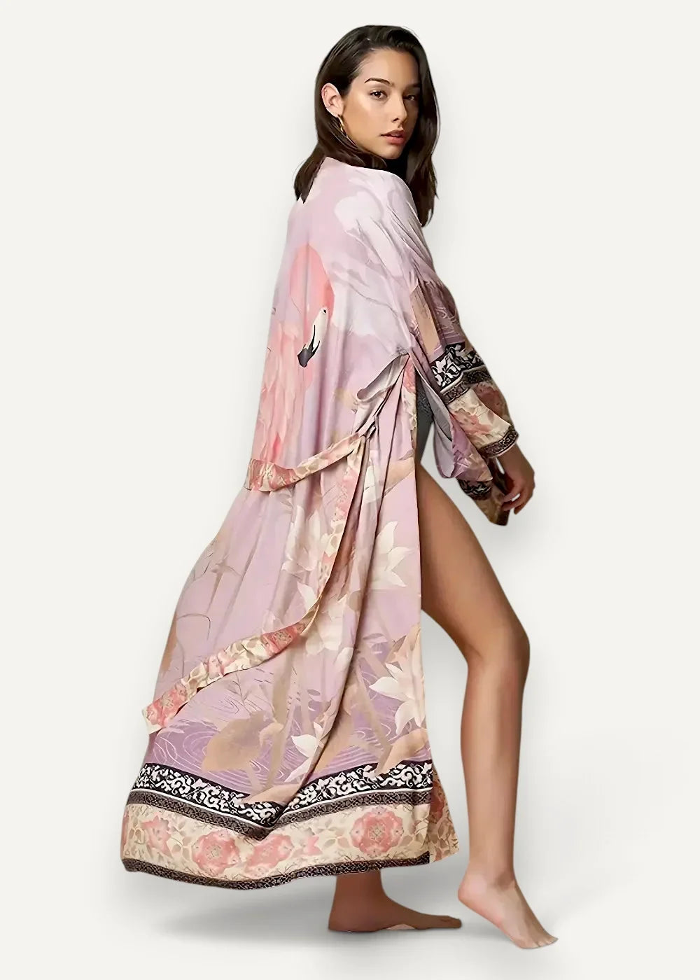 Sheer kimono with long sleeves flowing pink and beige floral fabric and black and gold patterned hem