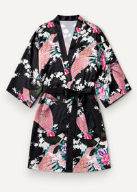 Short black satin robe with vibrant pink and white peacock floral pattern and matching black belt tied at waist
