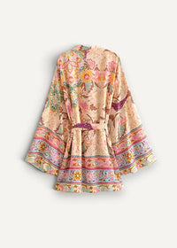 Short kimono dress in soft peach with vibrant floral paisley pattern wide sleeves and decorative hem trim