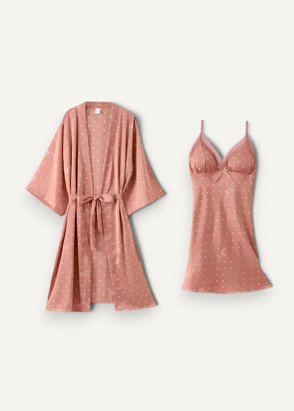 A soft rose pink satin robe with white polka dots and a matching tie belt from a short nightgown and robe set