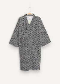 Black and white wave-patterned cotton short yukata kimono hanging on a wooden hanger showing the front side