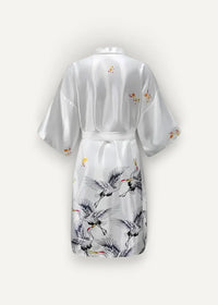 White satin silk kimono robe women’s featuring elegant black and gold crane illustrations on the fabric