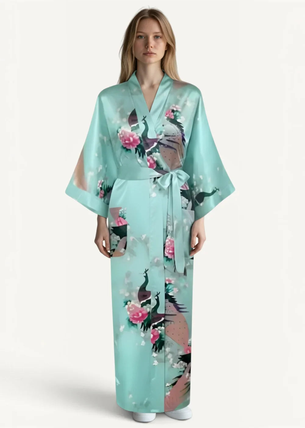 A light teal silk robe for women with a delicate peacock and pink flower print tied at the waist with sash