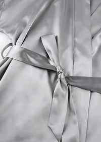 Silver satin robe with matching belt tied in a neat bow made of silk satin for comfortable loungewear