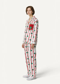 Striped kimono pajamas in white with red vertical stripes green circular motifs and a red chest patch