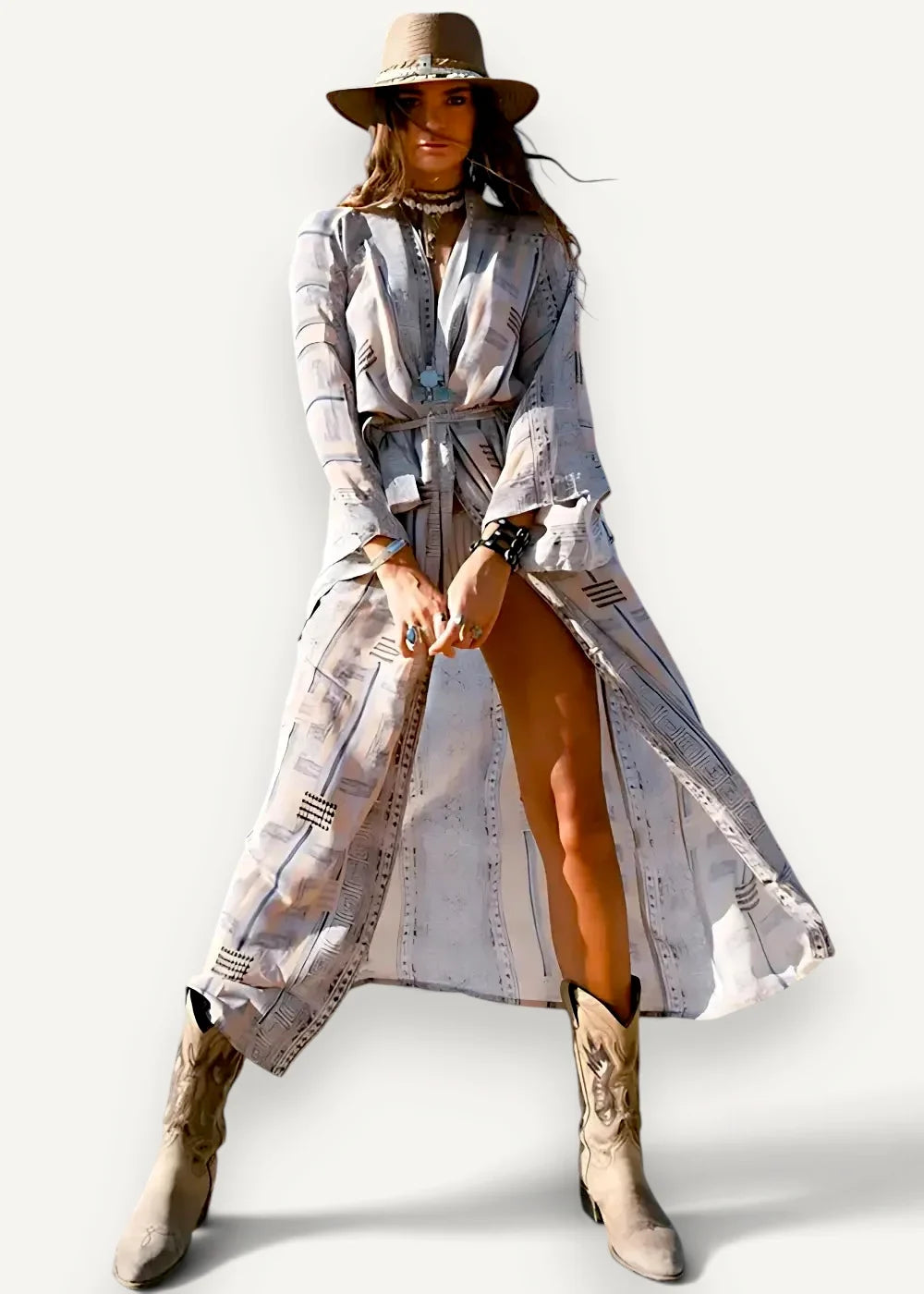 A woman wears a long flowing light gray and white striped kimono shirt dress with a tie belt