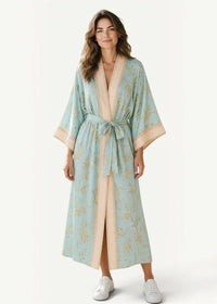 A light blue summer beach kimono floral robe with beige trim and gold botanical patterns with matching belt