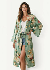 A flowing sage green summer kimono cover up with a vibrant cream red and green floral pattern