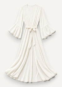 A flowing white summer kimono wrap dress with bell sleeves and a tied waistband