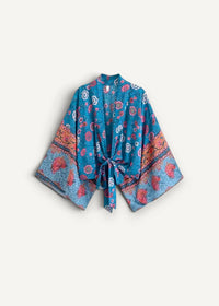 A vibrant turquoise swim kimono jacket with pink and orange floral pattern wide sleeves and tied waist