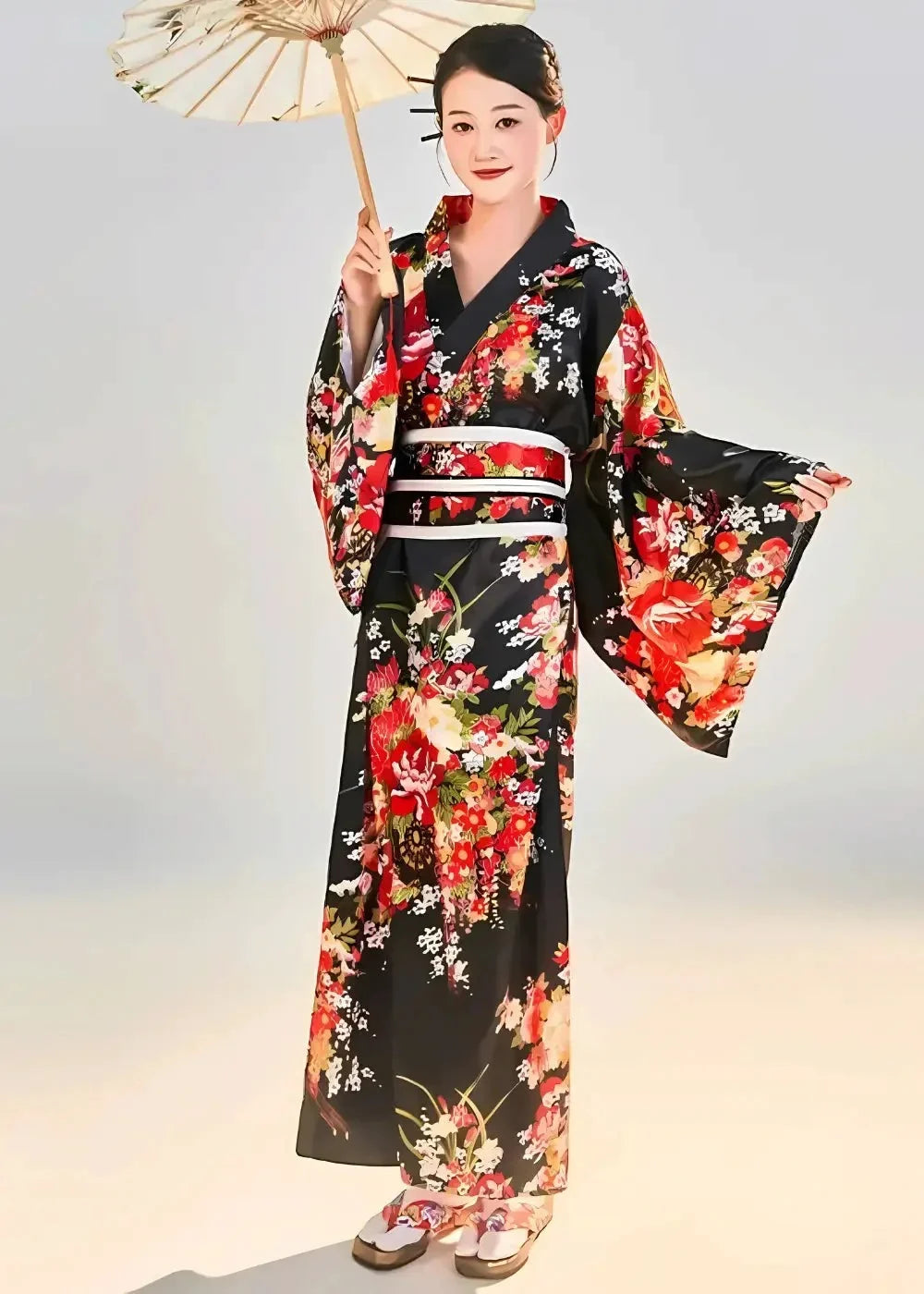 A woman wearing a traditional black Japanese kimono with vibrant red orange and white floral patterns