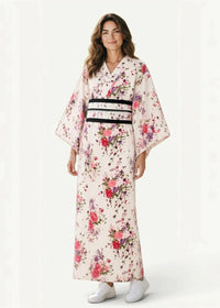 A woman wears a traditional Japanese white kimono with vibrant pink and purple floral patterns in cream fabric