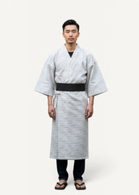 Traditional yukata featuring light gray fabric with subtle geometric patterns and a contrasting black obi belt