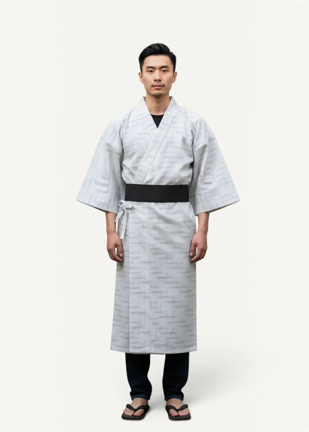 Traditional yukata featuring light gray fabric with subtle geometric patterns and a contrasting black obi belt