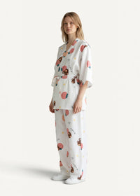 White cotton kimono pajamas with a playful strawberry and cartoon bear pattern on soft flowing fabric