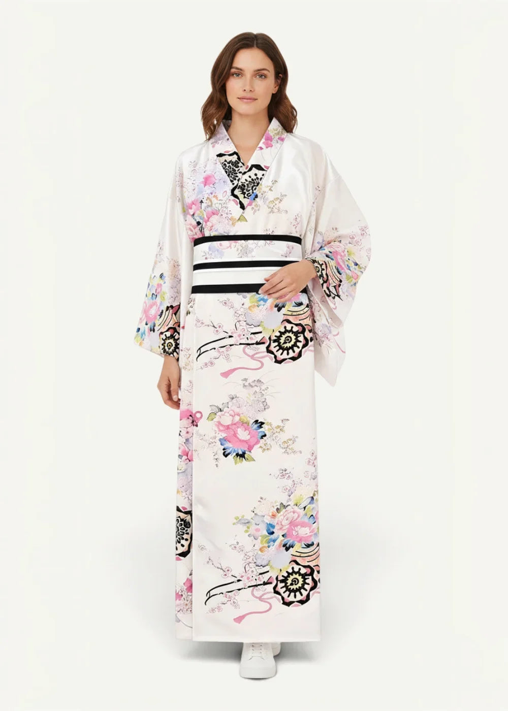 White Japanese kimono with delicate pink and black floral patterns and a bold black and white striped obi belt