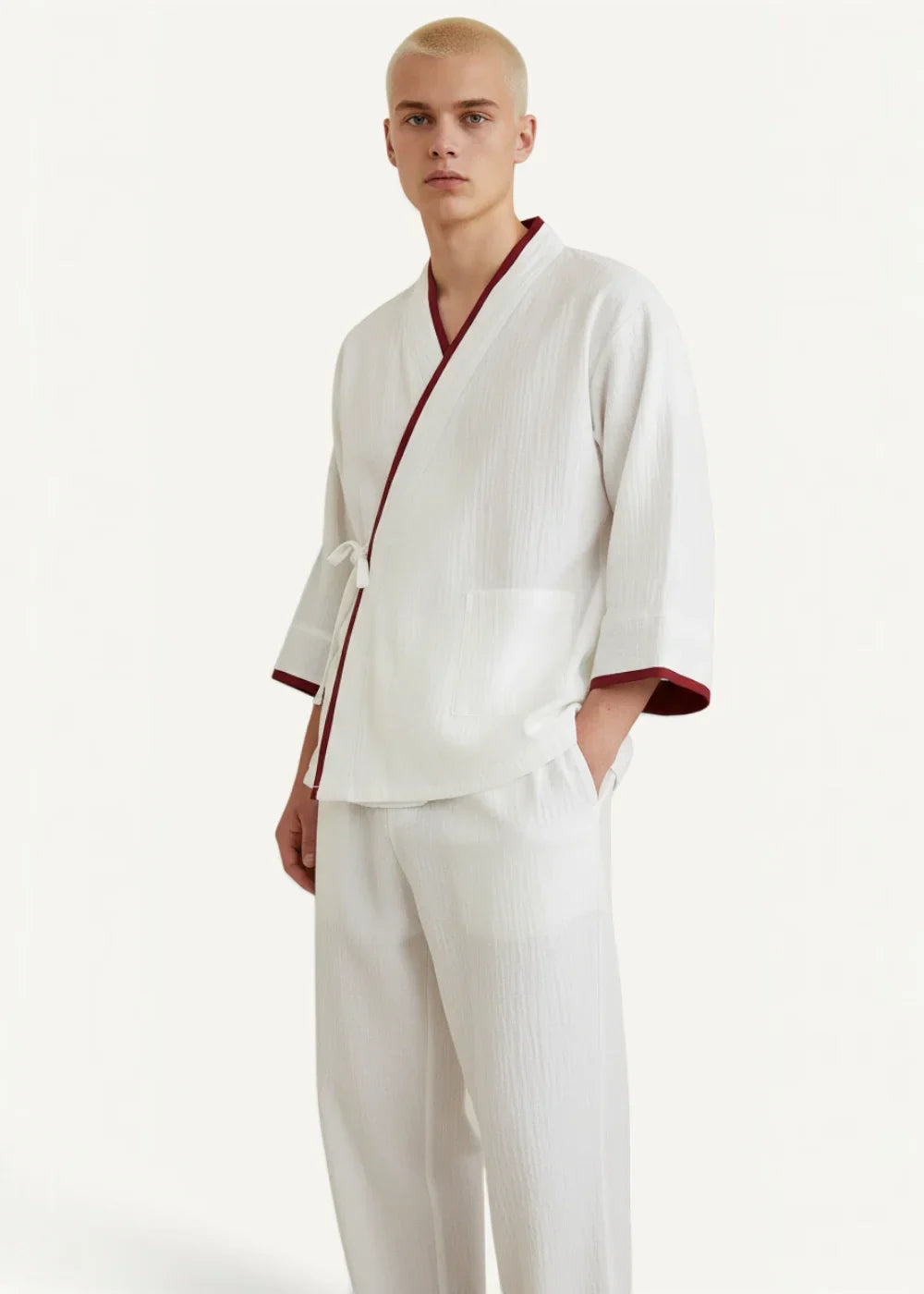 Man wearing white Japanese kimono pajamas with burgundy trim and matching pants