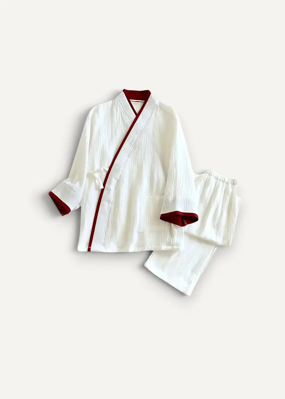 White Japanese kimono pajamas featuring a white textured fabric with red trim on collar cuffs and front placket
