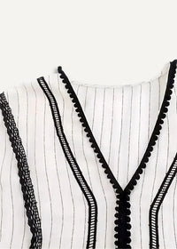 White kimono dress with black vertical stripes and decorative lace trim along the neckline
