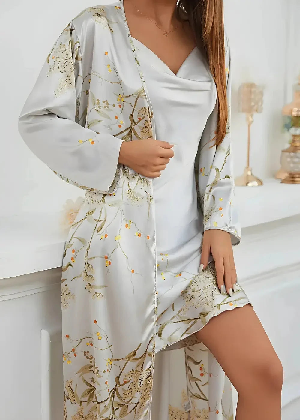 A flowing light gray satin robe with delicate gold and beige floral embroidery from a white nightgown and robe set