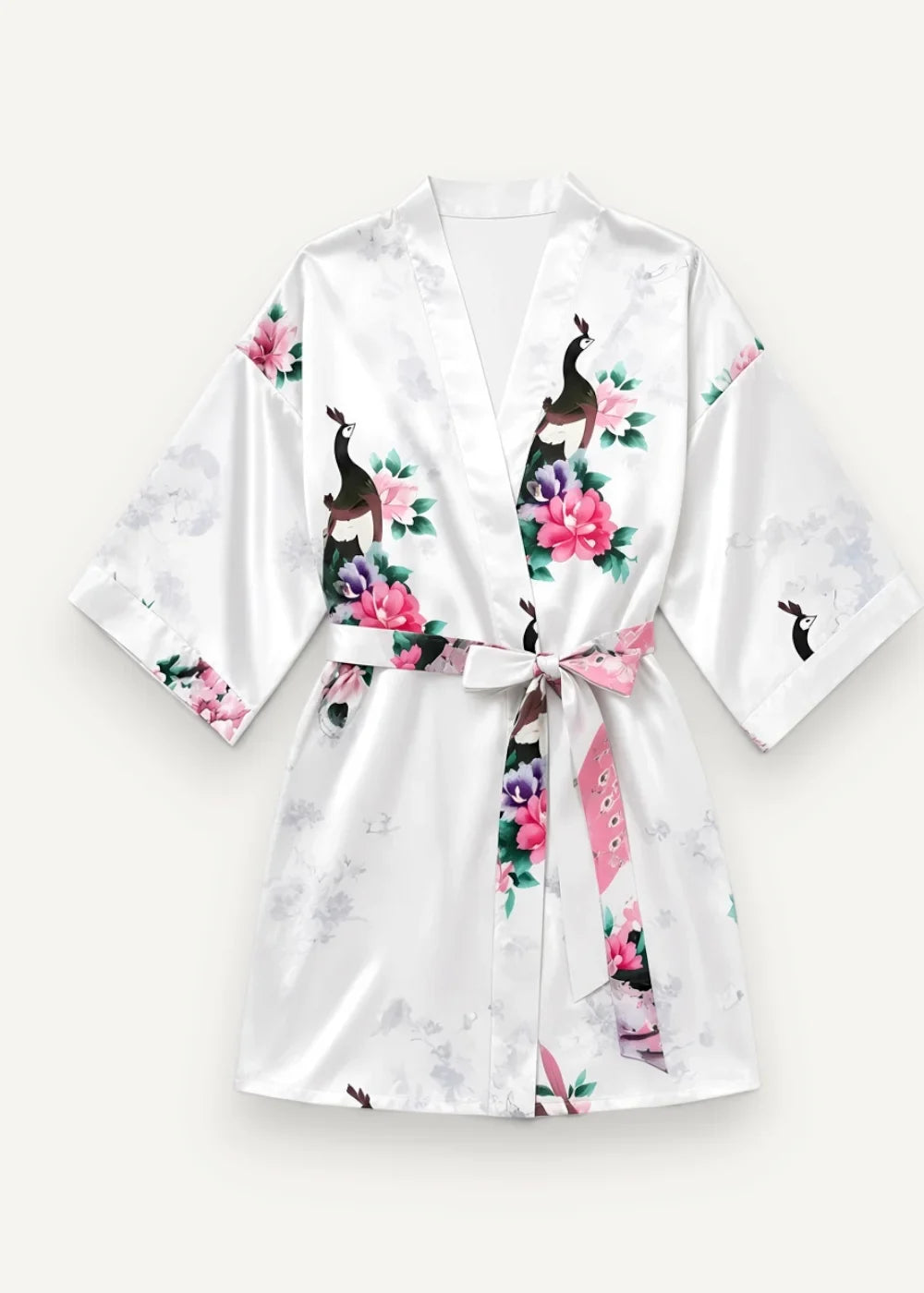White satin robe with floral and peacock print featuring pink blossoms and black and white birds on glossy fabric