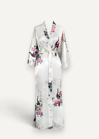 White silk robe in satin with pink black and green floral and peacock pattern shown from the back side