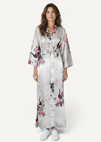 White silk robe in flowing silver satin with pink and black floral patterns and a belted waist with three quarter sleeves