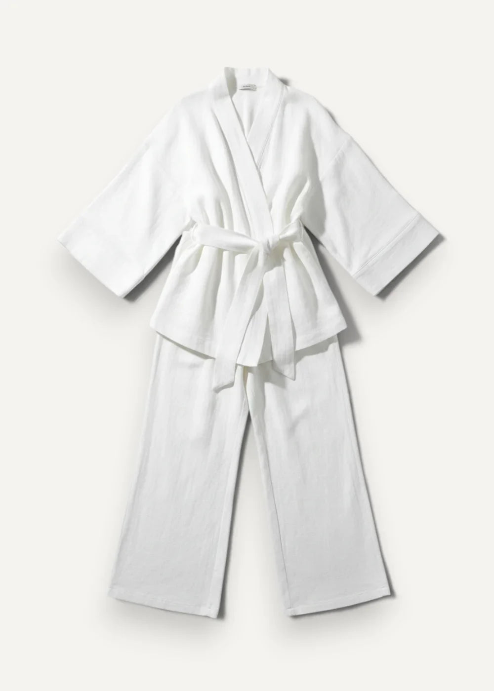 White women’s kimono pajamas featuring a white cotton robe with matching wide-leg pants tied at the waist