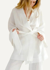 A flowing white silk kimono pajamas for women with a wide self-tie belt and soft pleats