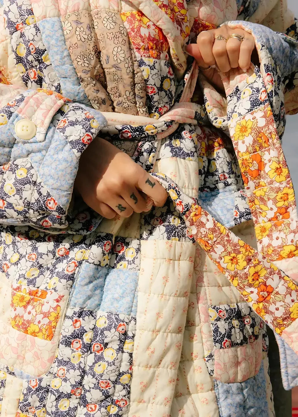 Winter kimono patchwork quilted robe with floral pattern in pastel blue cream orange and navy tones with stitched seams