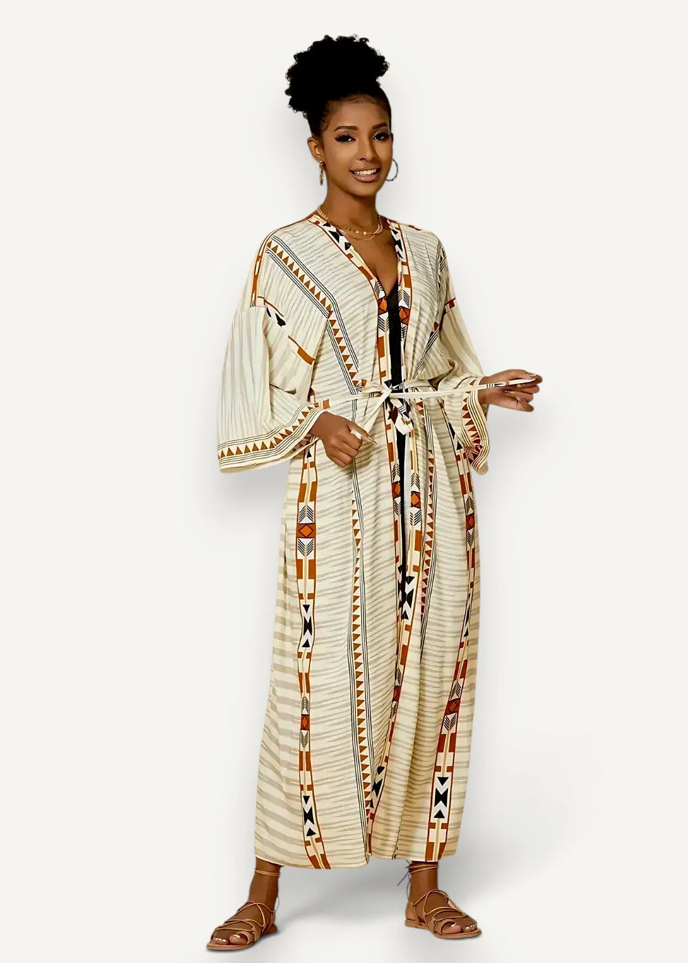 A woman wears a long flowing beige and brown geometric patterned women’s kimono cardigan tied at the waist