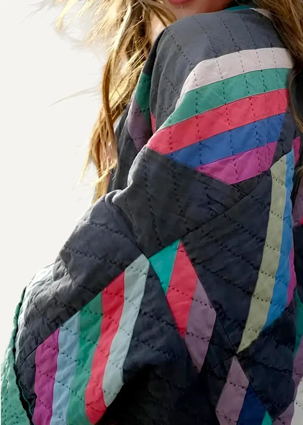 Women’s kimono jacket with quilted fabric and bold geometric stripes in pink teal and purple on dark gray base