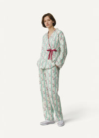A woman wearing a women’s kimono set with mint green white stripes floral pattern and burgundy ribbon belt