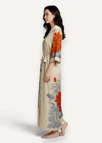 Women’s long satin robe in flowing beige silk with vibrant orange and gray floral patterns and a self-tie belt