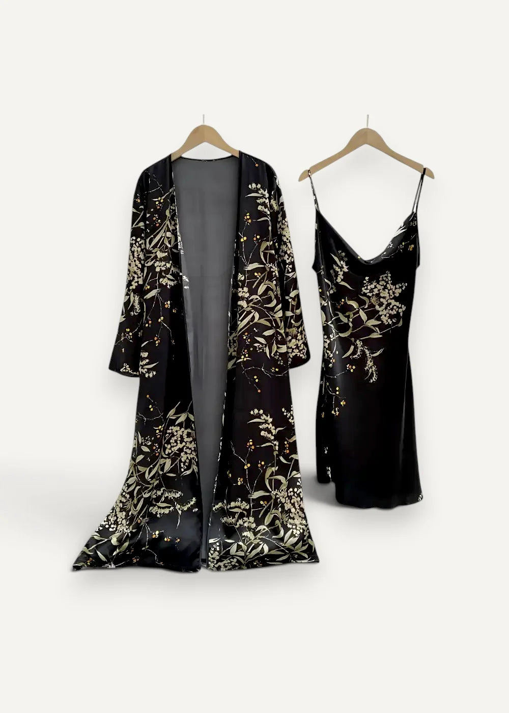 Black velvet women’s robe with gold floral embroidery hanging on wooden hanger from nightgown and robe set