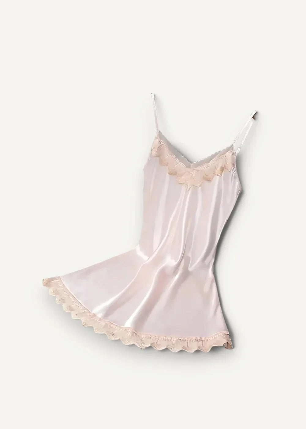 A delicate blush pink satin slip dress with lace trim along the neckline and hem in a women’s satin nightgown set