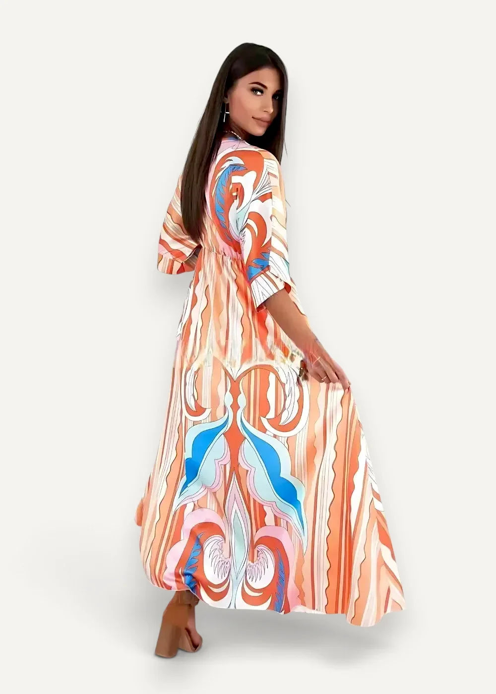 A flowing floor-length wrap kimono dress with vibrant orange and blue abstract pattern with white accents