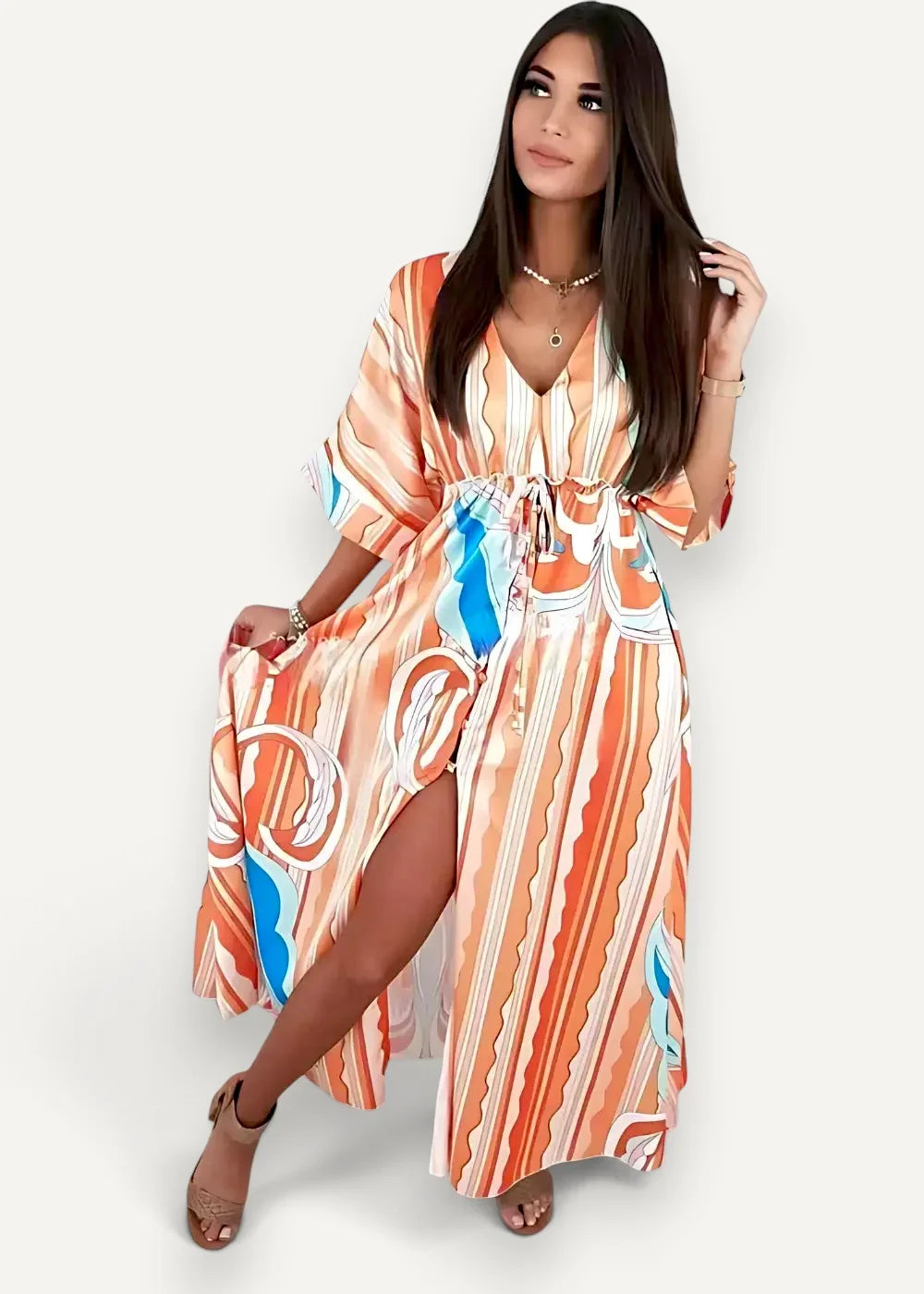 A flowing wrap kimono dress with long sleeves in vibrant orange and blue abstract stripes and a side slit