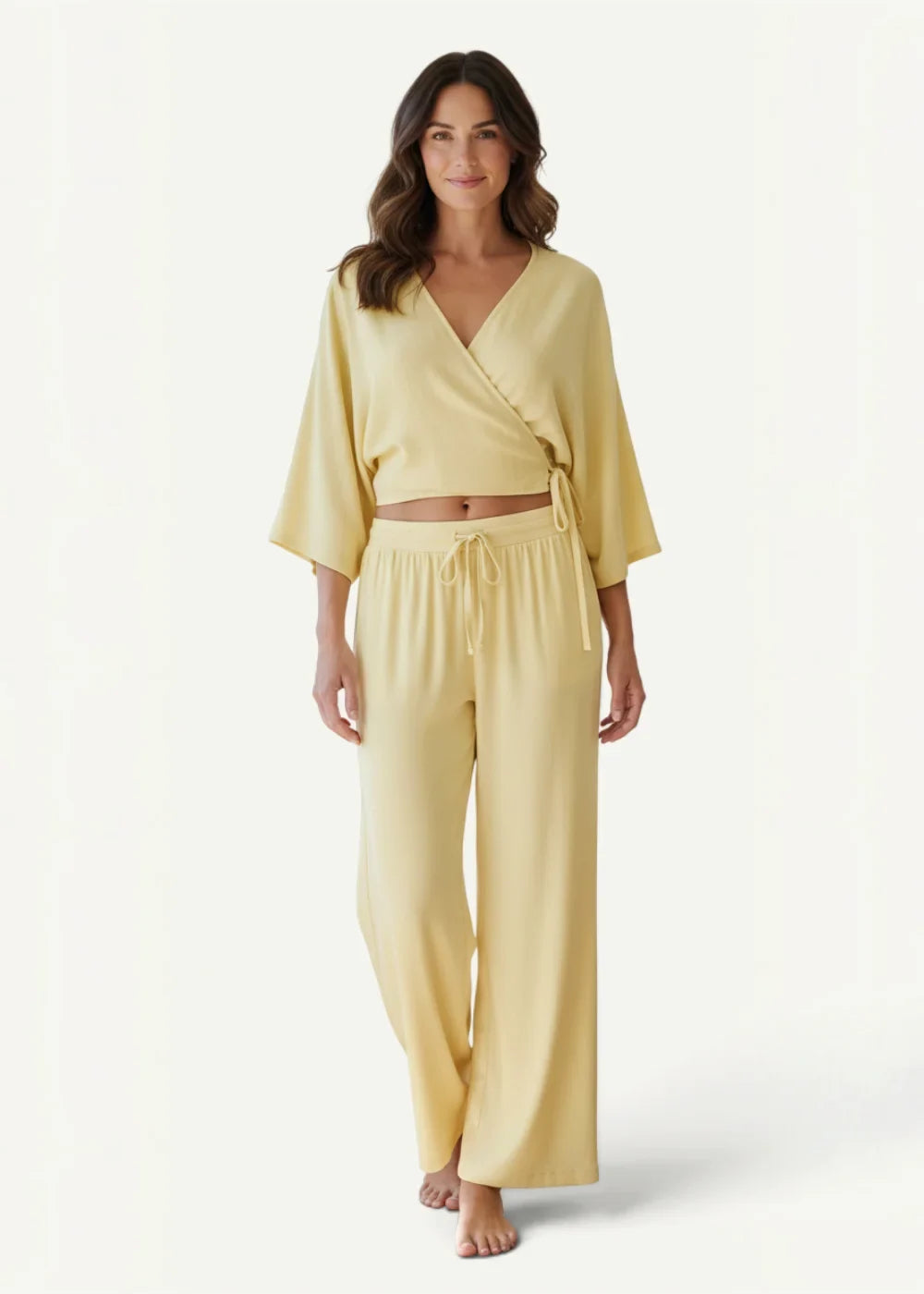 A soft pale yellow wrap-style kimono set with flowing fabric and a drawstring waistband for loungewear