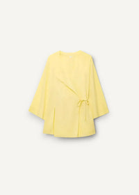 A soft yellow kimono set featuring a wrap-style coat with subtle texture and matching waist tie