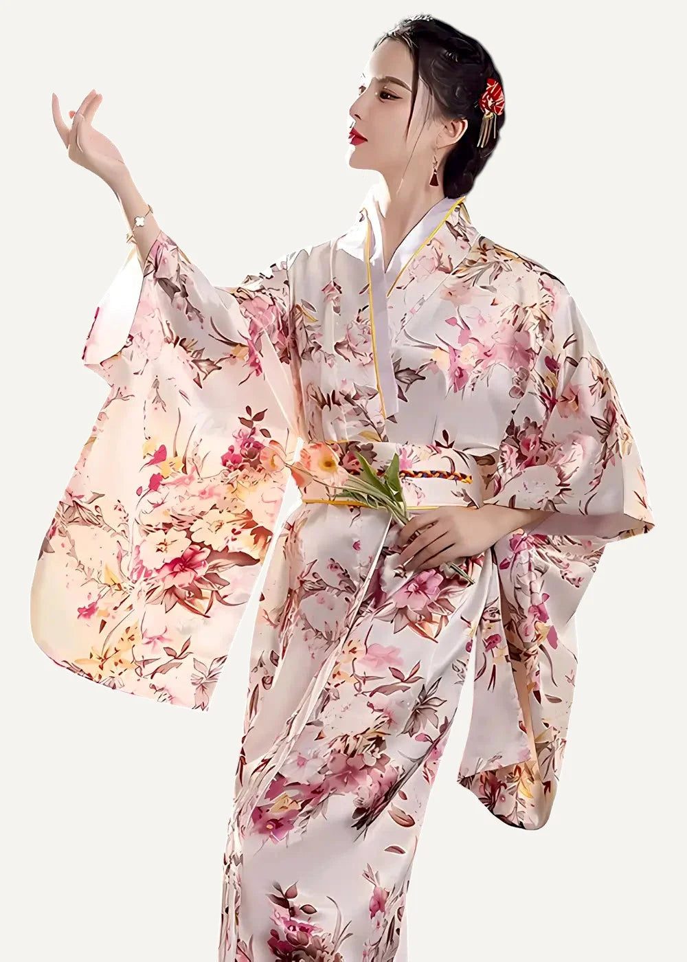 A flowing light pink floral-patterned silk yukata bathrobe with wide sleeves and a matching obi belt