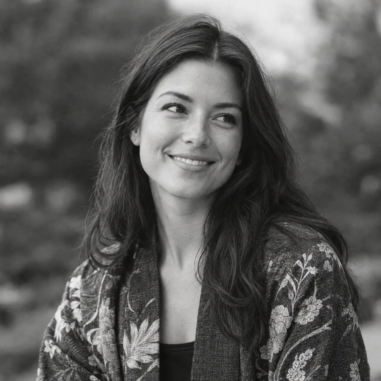 Zen Kimono review: Jessica H. from Seattle, WA smiling in a floral print kimono jacket outdoors